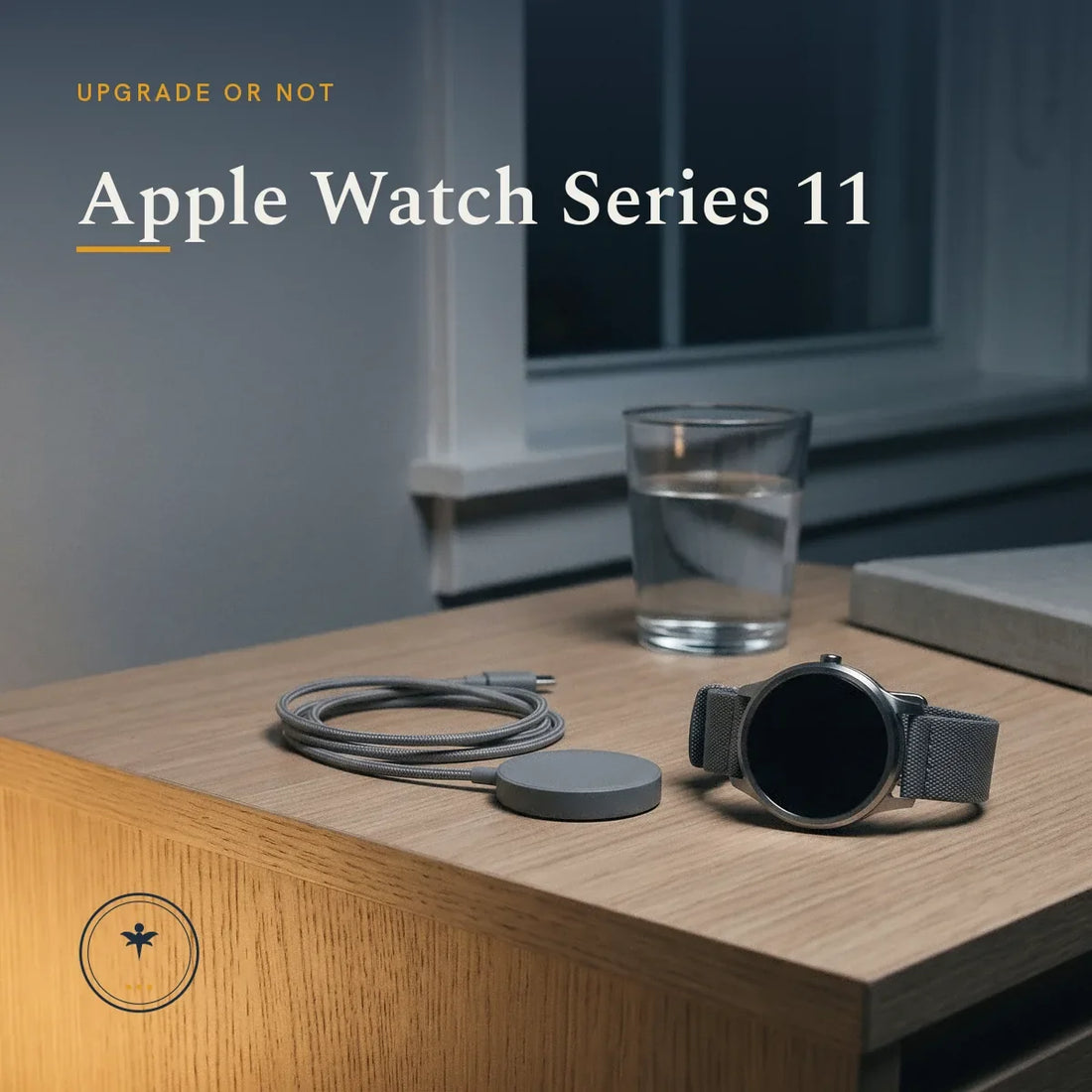 A plain round-faced smartwatch with a dark screen on a bedside table at night, beside a round charging puck with coiled cable, a glass of water and a book, lit by a single lamp.